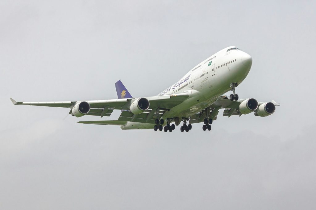 A large jetliner flying through a cloudy sky